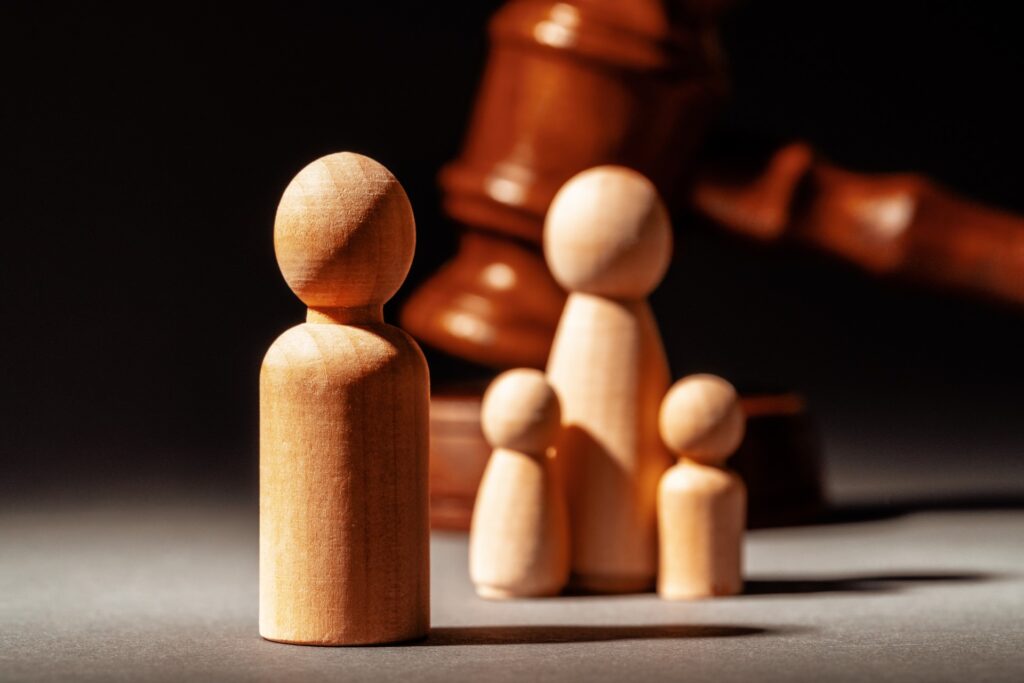 Wooden Pawns standing in front of a gavel | Featured image for the Responding To A Police Order for The Law People.