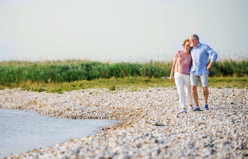 An older couple walking along the riverbanks | Featured Image for the Spousal Maintenance Lawyer service landing page